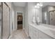 Well-lit bathroom with double vanity, marble countertops, and tile floors at 171 School Side Dr, Spring Lake, NC 28390