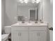 Bathroom featuring double sinks, a toilet and white cabinets for ample storage at 171 School Side Dr, Spring Lake, NC 28390
