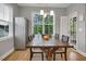 Bright dining area with large window, wood table and floors, stainless steel refrigerator at 171 School Side Dr, Spring Lake, NC 28390