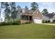 Charming two-story home featuring a stone facade, two-car garage, and manicured lawn at 171 School Side Dr, Spring Lake, NC 28390