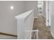 Upstairs hallway featuring neutral carpet and paint tones leading into other rooms of the house at 171 School Side Dr, Spring Lake, NC 28390