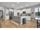 Open kitchen design with island seating, modern cabinets, and stainless appliances at 171 School Side Dr, Spring Lake, NC 28390