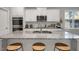 Stylish kitchen island with granite counters, bar stool seating, and sink at 171 School Side Dr, Spring Lake, NC 28390
