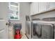 Functional laundry room with washer, dryer, and white cabinets above at 171 School Side Dr, Spring Lake, NC 28390