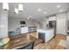 Open-concept living area with fireplace, dining area, and modern kitchen features stainless steel appliances at 171 School Side Dr, Spring Lake, NC 28390