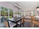 Dining room with a modern chandelier, dark wood table, and outdoor views from sliding glass doors at 2006 Cross Bones Blvd # 34, Durham, NC 27703