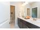 Bright bathroom featuring a double sink vanity with modern fixtures and a separate toilet and shower area at 205 Riverine Dr, Pittsboro, NC 27312