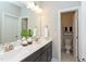 A bathroom showcasing a double sink vanity with modern fixtures, a large mirror, and a separate toilet at 205 Riverine Dr, Pittsboro, NC 27312
