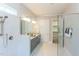 Bright bathroom with glass shower, dual vanity, white tile, granite countertops, and neutral-colored gray cabinets at 205 Riverine Dr, Pittsboro, NC 27312