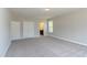 Expansive bedroom with carpet, two windows, and neutral paint, including a view of a full bathroom, offering comfort at 205 Riverine Dr, Pittsboro, NC 27312