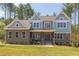 Charming two-story home showcasing a stone facade and varied siding for enhanced curb appeal at 205 Riverine Dr, Pittsboro, NC 27312