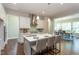 Modern kitchen featuring a large island with seating and stainless steel appliances open to the dining room at 205 Riverine Dr, Pittsboro, NC 27312