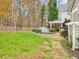 Backyard with large grassy area, treeline and covered patio at 206 Arbor Dr, Elon, NC 27244