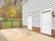 Back of house with brick facade, two entrances and iron fence at 206 Arbor Dr, Elon, NC 27244