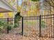 Enclosed backyard with black aluminum fence offers privacy and security with colorful fall foliage at 206 Arbor Dr, Elon, NC 27244