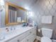 Bathroom with patterned wallpaper, bright vanity lighting and tiled floors at 206 Arbor Dr, Elon, NC 27244