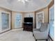 Bright bedroom with a comfortable sitting area featuring multiple windows, chair, and dresser at 206 Arbor Dr, Elon, NC 27244