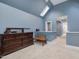 A bright bedroom with a skylight, large dresser and access to hallway at 206 Arbor Dr, Elon, NC 27244