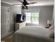 Cozy bedroom featuring a ceiling fan, large window, and comfortable furnishings at 206 Arbor Dr, Elon, NC 27244
