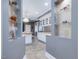 Convenient butler's pantry featuring floating glass shelves, cabinets, and tiled floors at 206 Arbor Dr, Elon, NC 27244