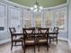 Dining room features hardwood table with large windows allowing for natural light and views at 206 Arbor Dr, Elon, NC 27244