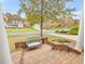 Inviting front porch features a vintage green wicker bench, a brick-paved walkway, and a lush green lawn at 206 Arbor Dr, Elon, NC 27244