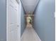 Long hallway with carpet and well-lit with a white door on the left side at 206 Arbor Dr, Elon, NC 27244