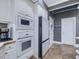 White kitchen appliances and cabinets, with gray walls and tile flooring at 206 Arbor Dr, Elon, NC 27244
