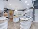 Bright kitchen with two islands, white cabinets, and tile flooring at 206 Arbor Dr, Elon, NC 27244