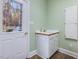 Laundry room with utility sink, wood counters, and a door to the outside at 206 Arbor Dr, Elon, NC 27244