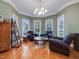 Cozy living room with hardwood floors, large windows, and comfortable seating around a decorative coffee table at 206 Arbor Dr, Elon, NC 27244