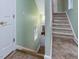 Carpeted staircase leading to a lower level with access to exterior at 206 Arbor Dr, Elon, NC 27244