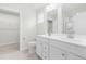 Bathroom with double vanity sinks, tile floor and view of the closet and shower at 21 Artesa Ct, Fuquay Varina, NC 27526