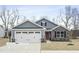 Charming home with stone accents, red front door, and a two-car garage at 21 Artesa Ct, Fuquay Varina, NC 27526