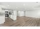 Bright living space with hardwood floors and kitchen with stainless steel appliances and granite countertops at 21 Artesa Ct, Fuquay Varina, NC 27526
