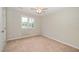 A light and airy bedroom has neutral walls, carpet flooring, a ceiling fan, and a window for lots of light at 2108 Quail View Trail, Raleigh, NC 27604