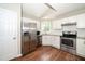 Charming kitchen with white cabinets, stainless steel appliances, and granite countertops at 2108 Quail View Trail, Raleigh, NC 27604