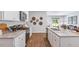 Stylish kitchen featuring white cabinets, granite counters, and stainless steel appliances and hardwood floors at 2140 Monk Dr, Haw River, NC 27258
