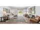 Cozy living room with hardwood floors, a comfortable sofa, a stylish rug, and a sliding door to the backyard at 2140 Monk Dr, Haw River, NC 27258