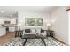 Bright living room featuring stylish decor, wood flooring, and an open concept layout leading into the kitchen at 2140 Monk Dr, Haw River, NC 27258
