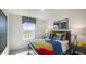 Colorful bedroom showcasing large window, posters and bright bedspread at 2156 Monk Dr, Haw River, NC 27258