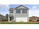 Charming two-story home with neat lawn, garage, and classic curb appeal at 2156 Monk Dr, Haw River, NC 27258