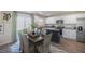 Eat-in kitchen with white cabinets, stainless steel appliances, and a wooden dining set at 2156 Monk Dr, Haw River, NC 27258