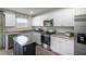 Well-lit kitchen with white cabinets, stainless steel appliances, and light countertops at 2156 Monk Dr, Haw River, NC 27258