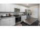 Well-appointed kitchen featuring stainless steel appliances, granite countertops, and stylish white cabinetry at 2156 Monk Dr, Haw River, NC 27258