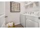 Functional laundry room with modern appliances, storage shelves, and decorative wall art at 2156 Monk Dr, Haw River, NC 27258
