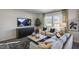 Comfortable living room with large windows, and a TV over a modern credenza at 2156 Monk Dr, Haw River, NC 27258