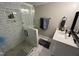 Modern bathroom featuring a glass enclosed shower with stone floor and white marble tiling, and a white vanity at 223 E Nash St, Spring Hope, NC 27882