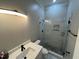 Stylish bathroom featuring a glass shower with white marble tiling and a white vanity with modern fixtures at 223 E Nash St, Spring Hope, NC 27882