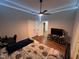 Cozy bedroom with hardwood floors, ceiling fan, and ensuite access at 223 E Nash St, Spring Hope, NC 27882